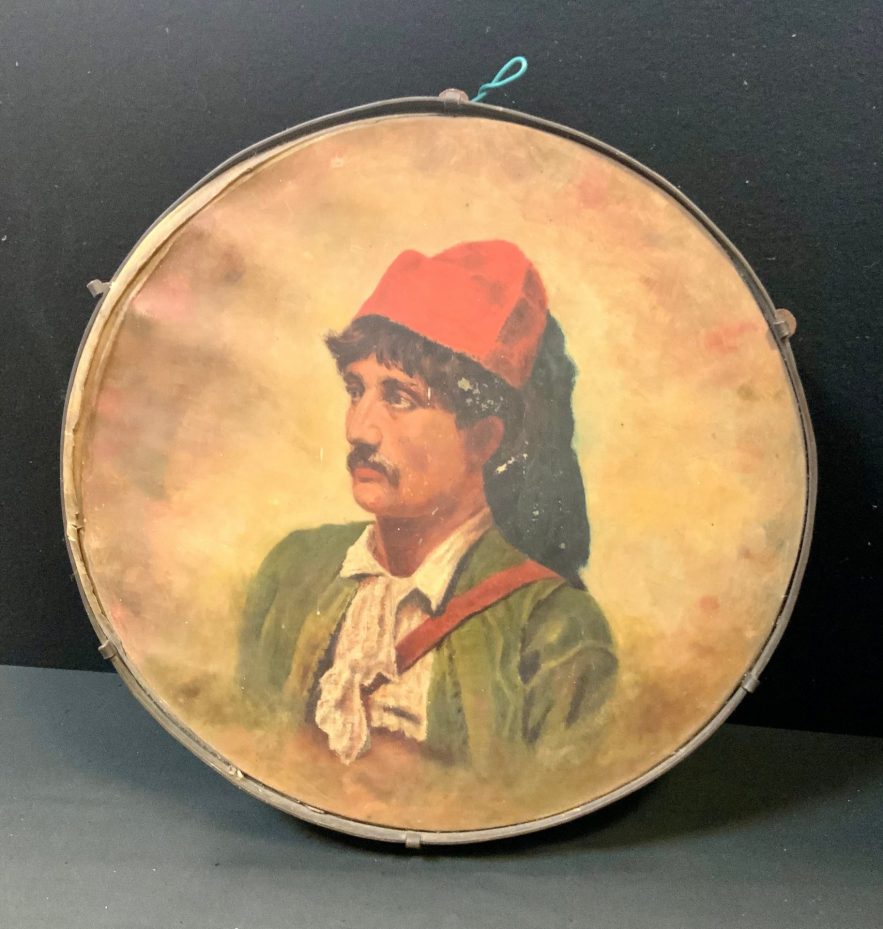 An early 20th century Italian tambourine, painted with a portrait of a gentleman, 33cm diam, probably Neapolitan, c.1910